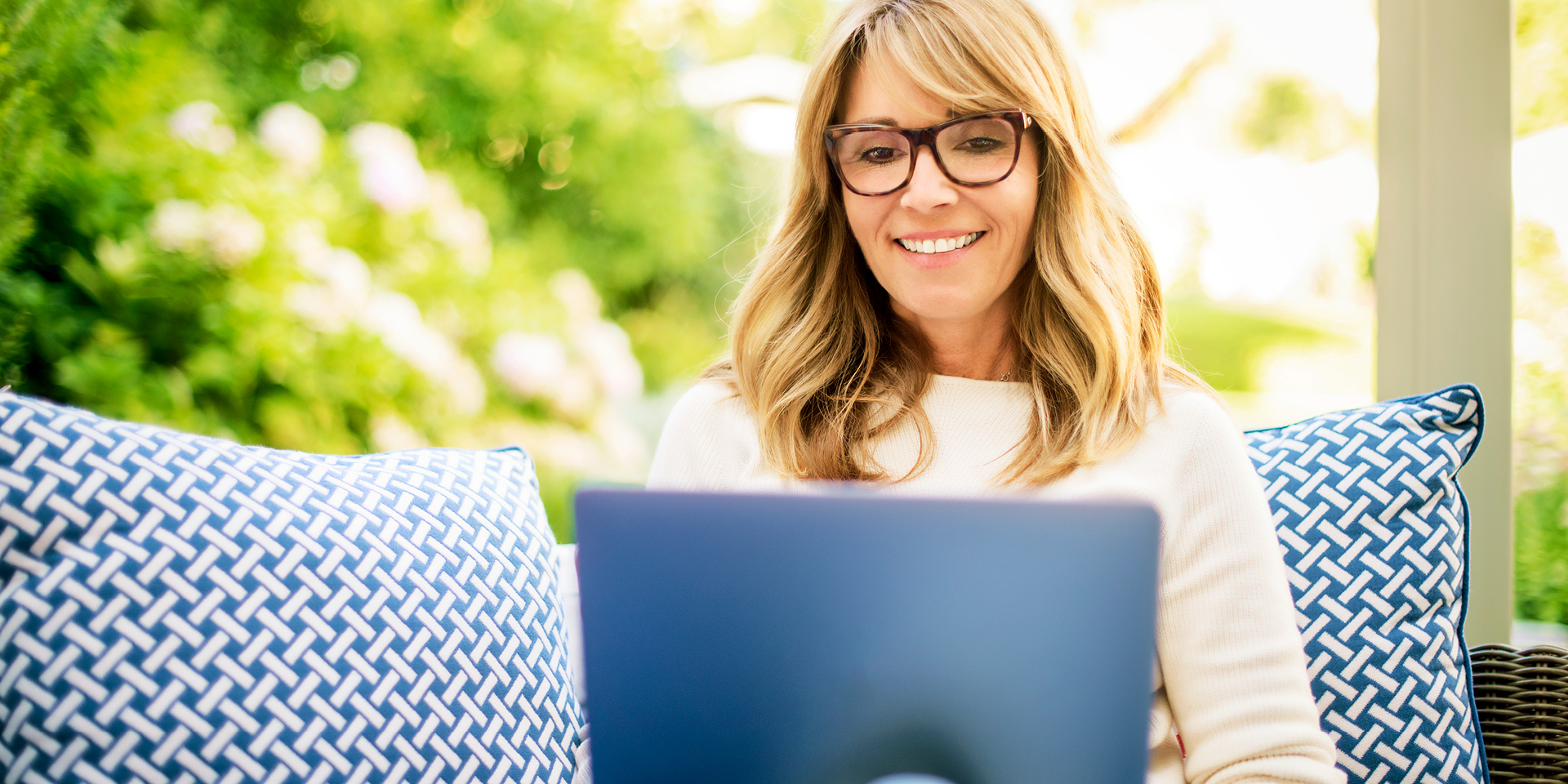 Woman seating comfortably while using her laptop | Doylestown Health