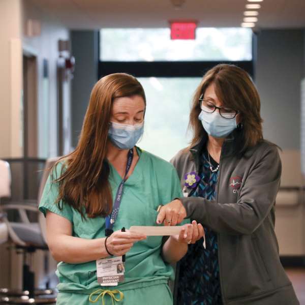Two nurses discussing a note | Doylestown Health