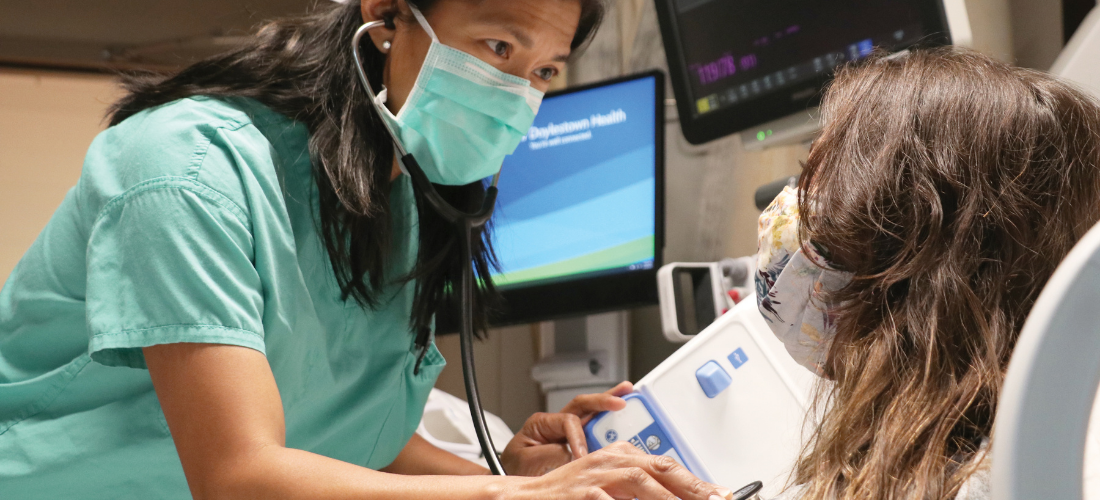 Critical care provider examining a patient | Doylestown Health