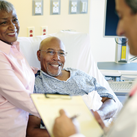 Patient in bed with wife and provider | Doylestown Health